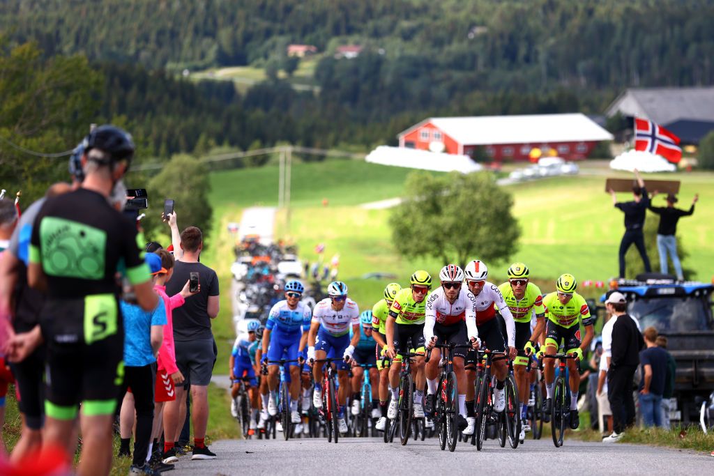 SKALLSTUGGU NORWAY AUGUST 13 LR Andr Rodrigues De Carvalho of Portugal and PierreLuc Perichon of France and Team Cofidis lead the peloton starting the climb to Strugstad 136m while fans cheer during the 9th Arctic Race Of Norway 2022 Stage 3 a 1777km stage from Namsos to Skallstuggu 474m ArcticRace on August 13 2022 in Skallstuggu Norway Photo by Michael SteeleGetty Images