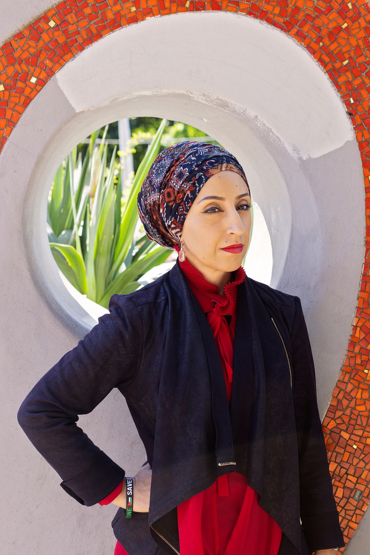 A woman poses looking at the camera.