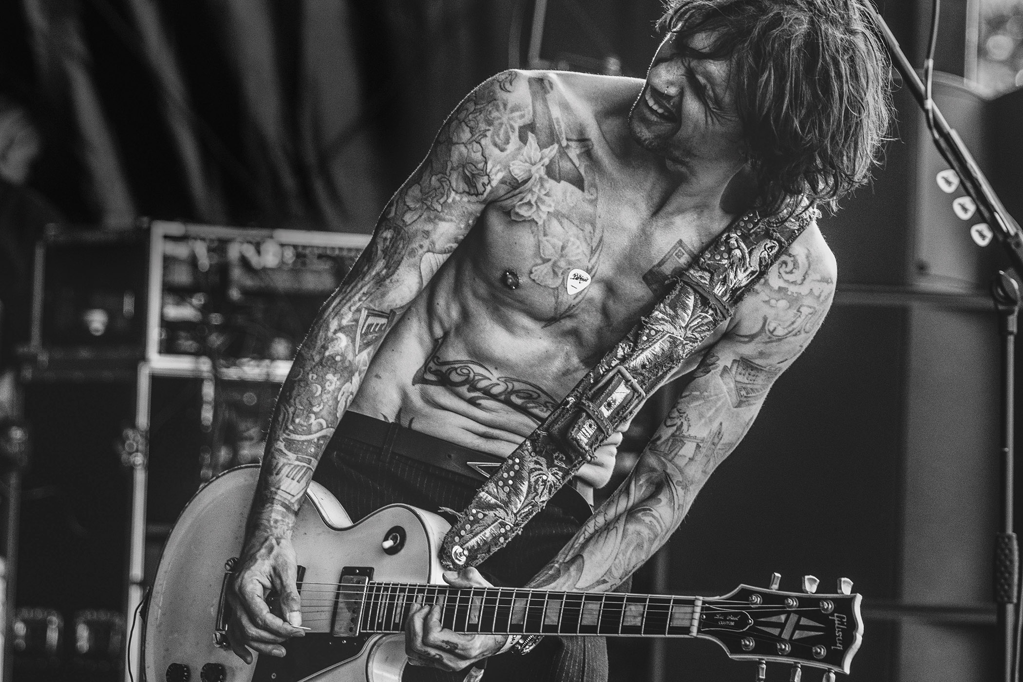 Justin Hawkins of the Darkness is shirtless onstage and rocking out.