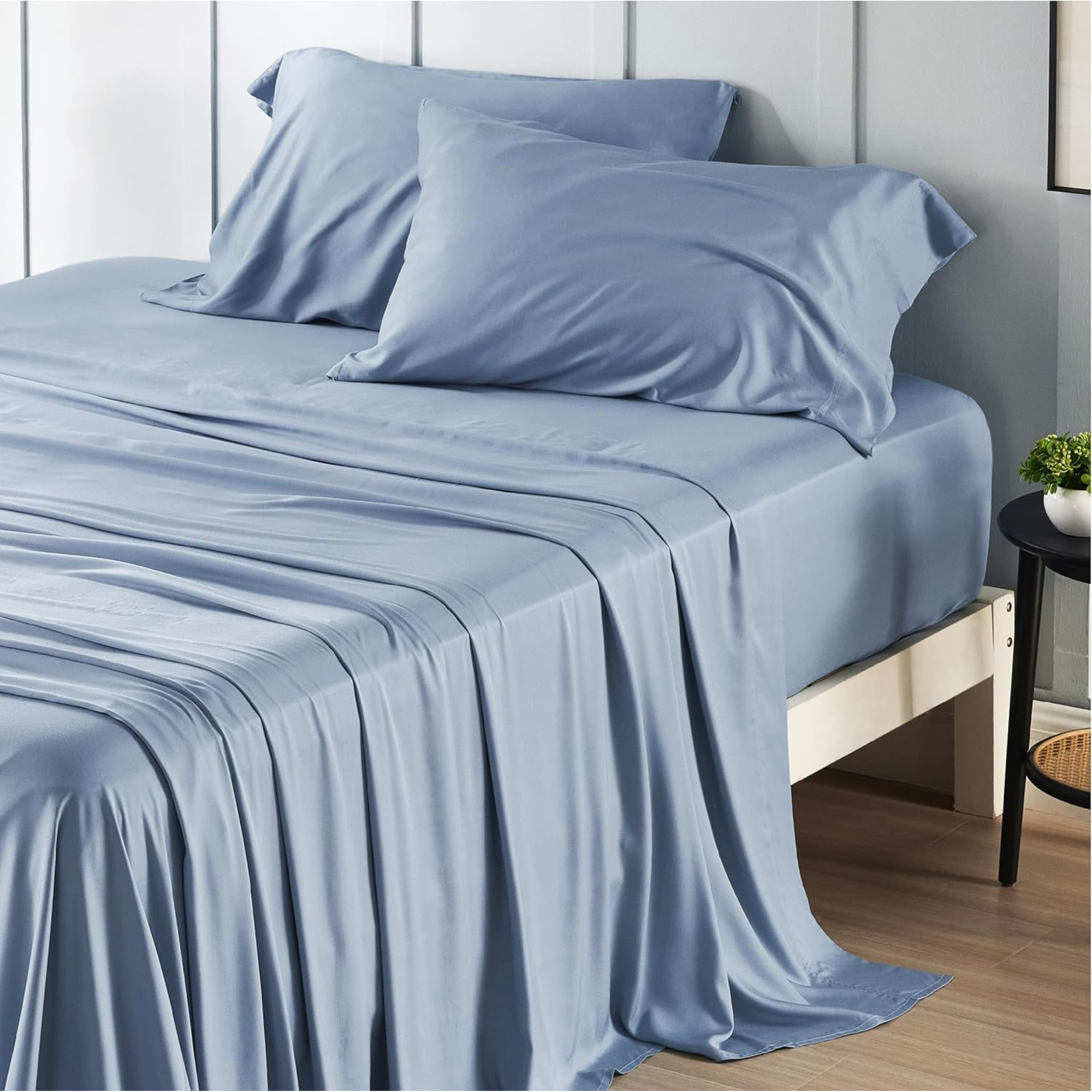 blue bedsheets on a bed with two pillows