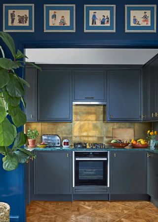 Blue kitchen with metallic backsplash and painted cabinets