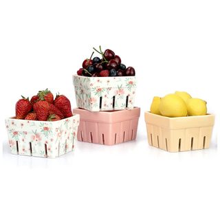 A set of 4 pastel and patterned ceramic berry baskets with strawberries and lemons