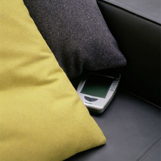 black sofa with yellow and grey cushions