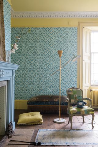blue wallpapered living room with yellow border work