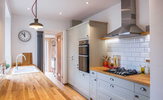 grey shaker style kitchen with wooden worktops