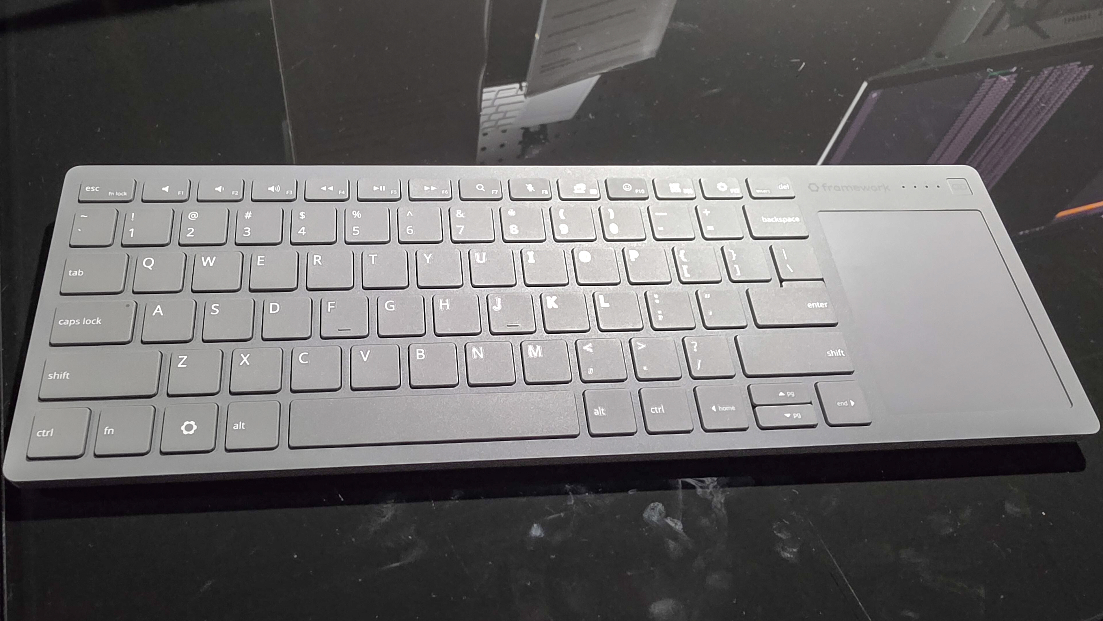 The Framework Wireless Touchpad Keyboard on a table