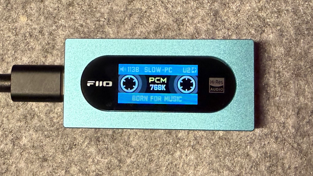 A photo of the front of the FiiO KA15 portable DAC playing PCM music