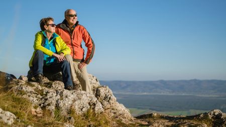 Senior couple on top of mountain enjoying the view