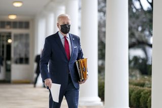 President Joe Biden walks along the Colonnade of the White House Thursday, Jan. 28, 2021, en route to the Oval Office.