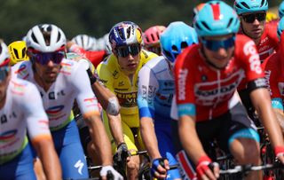 JumboVisma teams Belgian rider Wout Van Aert C wearing the overall leaders yellow jersey cycles with the pack of riders during the 4th stage of the 109th edition of the Tour de France cycling race 1715 km between Dunkirk and Calais in northern France on July 5 2022 Photo by Thomas SAMSON AFP Photo by THOMAS SAMSONAFP via Getty Images