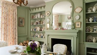 Country house dining room with a large mirror over a fireplace