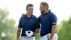 Shane Lowry with his arm around Rory McIlroy at the 2025 Zurich Classic