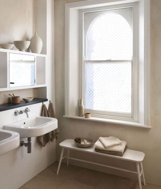 bathroom with cabinets and bench