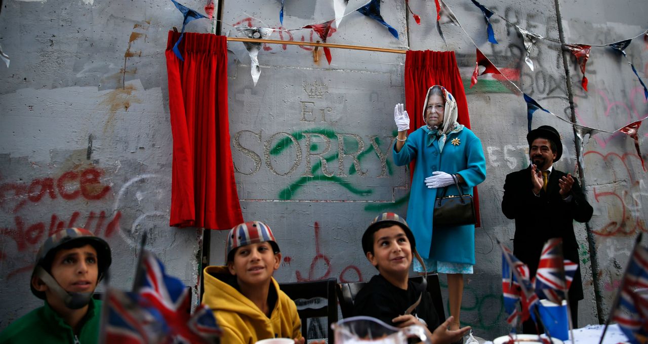 Palestinian children attend an event held by street artist Banksy on the 100th anniversary of the Balfour Declaration.