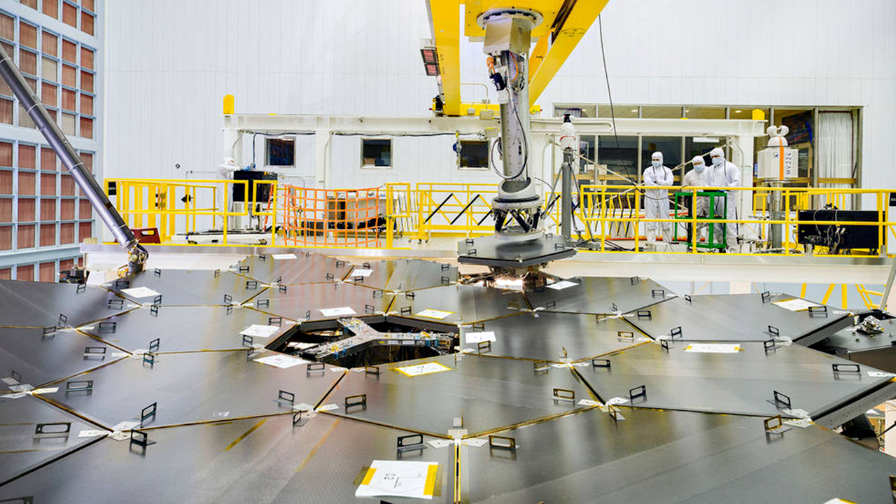An image of the back of the James Webb Space Telescope's 18 mirror segments being assembled in a clean room.