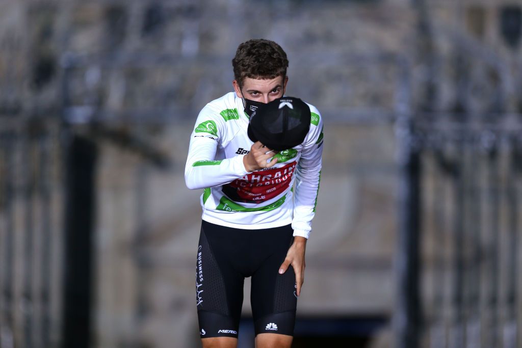 SANTIAGO DE COMPOSTELA SPAIN SEPTEMBER 05 Gino Mder of Switzerland and Team Bahrain Victorious celebrates winning the white best young jersey on the podium ceremony after the 76th Tour of Spain 2021 Stage 21 a 338 km Individual Time Trial stage from Padrn to Santiago de Compostela lavuelta LaVuelta21 ITT on September 05 2021 in Santiago de Compostela Spain Photo by Gonzalo Arroyo MorenoGetty Images