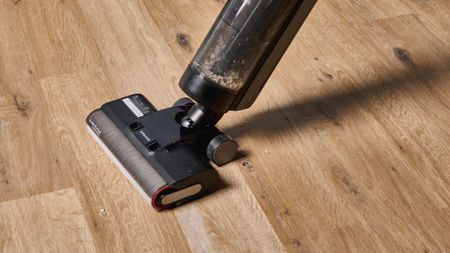 the dreame h12 pro wet and dry vacuum cleaner with a roller brush and a black exterior with two water tanks for clean and dirty water