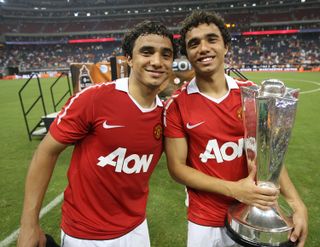 Manchester United pair Rafael and Fabio da Silva pose with the All Star trophy after a game against MLS All Stars in 2010.