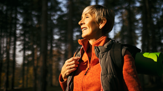 Woman with sunshine on her in woods