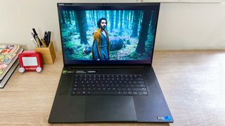 razer Blade 18 open on desk with The Green Knight playing on-screen