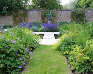 walled garden design with planted beds, water feature and sundial by Peter Reader