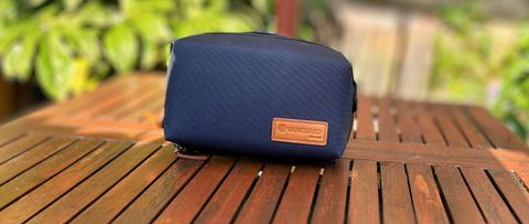 A blue-grey VEO City Bag Technical Pack sitting on a wooden garden table