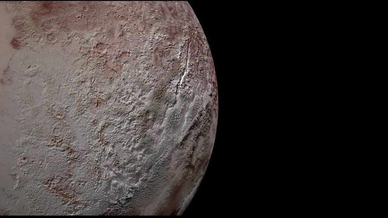 The surface of Pluto is peppered with craters and a rugged landscape.