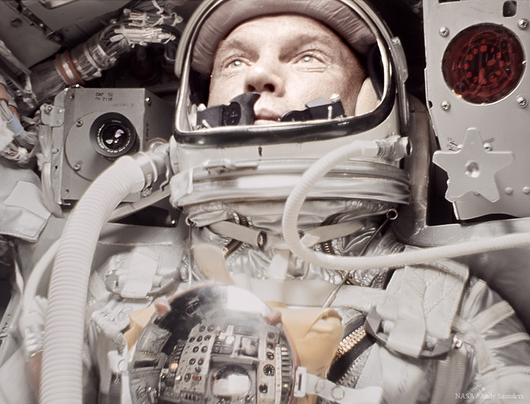 An early NASA astronaut inside a space capsule