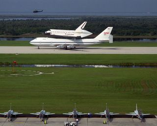The newest addition to NASA's space shuttle fleet, Endeavour, arrives at the Kennedy Space Center in Florida atop the 747 Shuttle Carrier Aircraft on May 7, 1991. Endeavour's first launch, the STS-49 mission, began with a flawless liftoff on May 7, 1992.