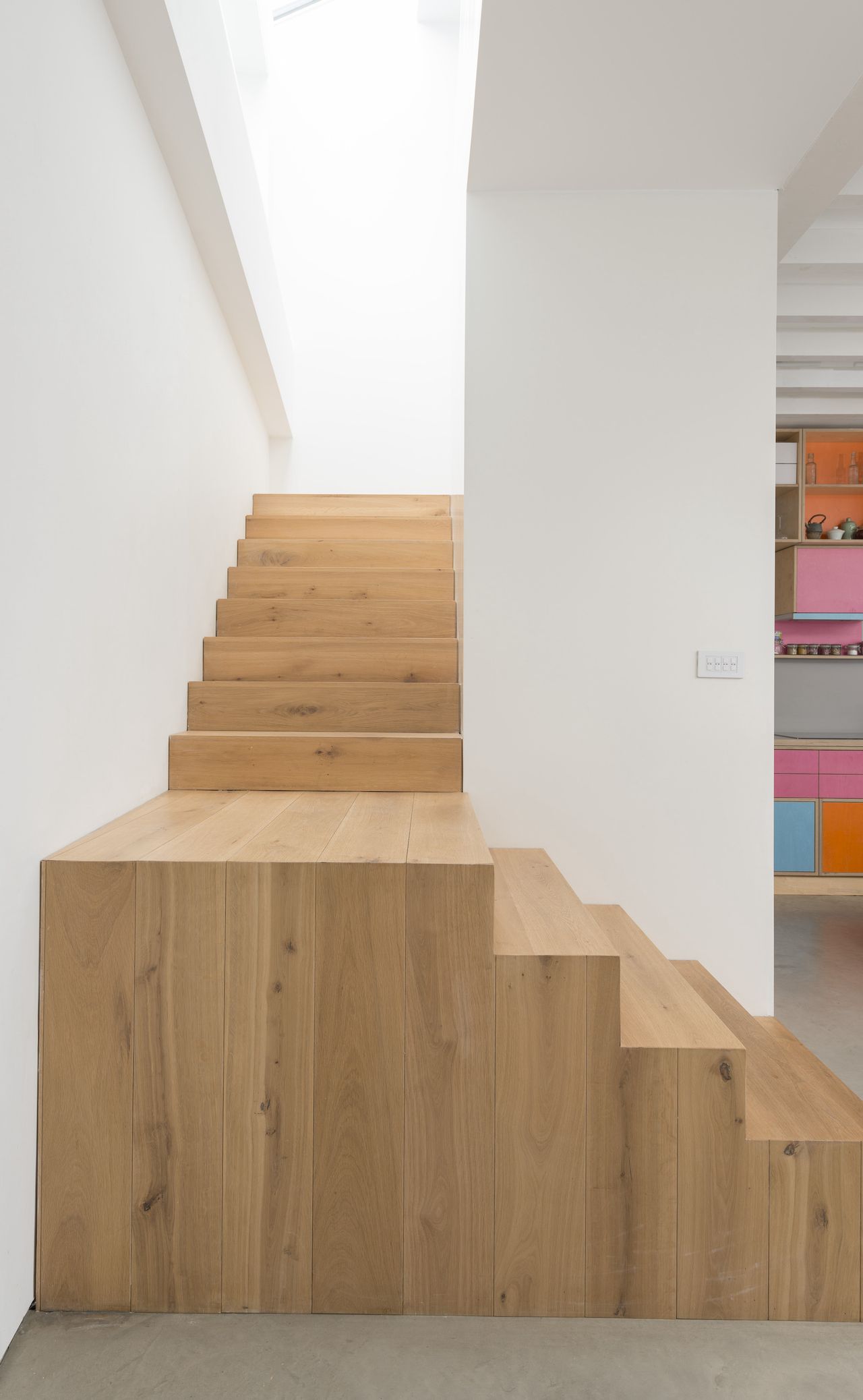 timber staircase up enclosed white stairwell
