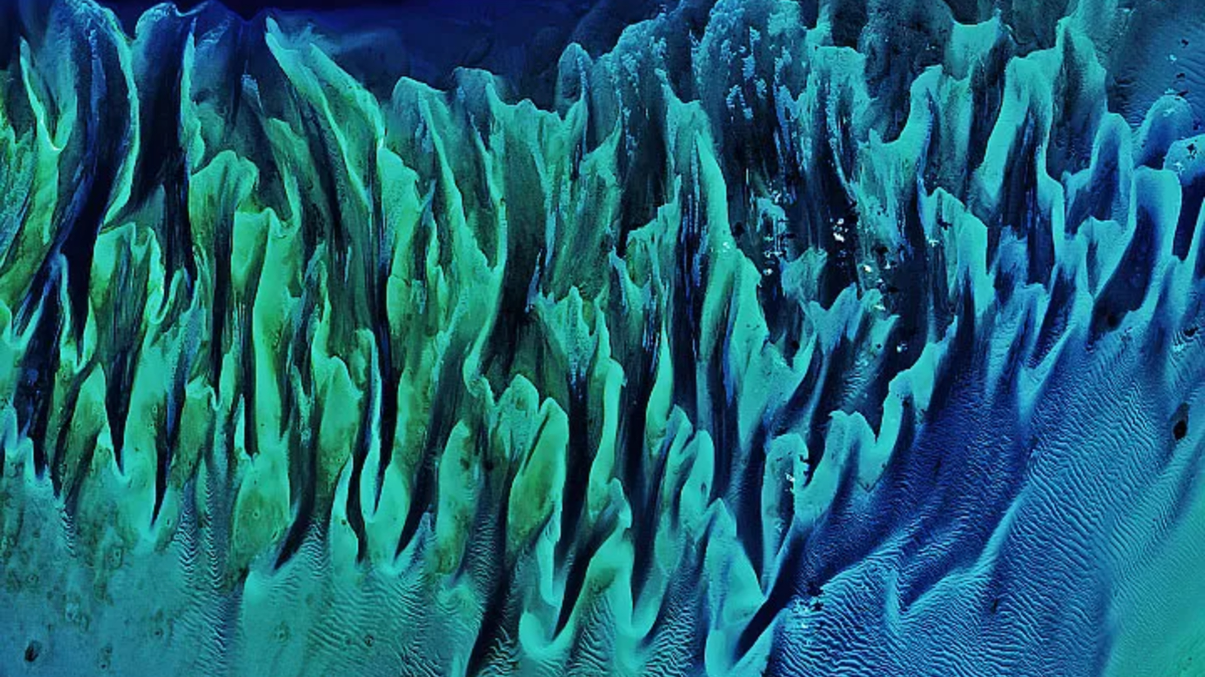 Close up satellite photo of the Great Bahama Bank showing the colorful folds of the sandbanks and seagrass 