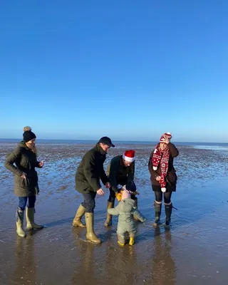 Princess Beatrice, Edo Mapelli Mozzi, Princess Eugenie, August Brooksbank and Sienna Mapelli Mozzi wearing coats and boats on the beach