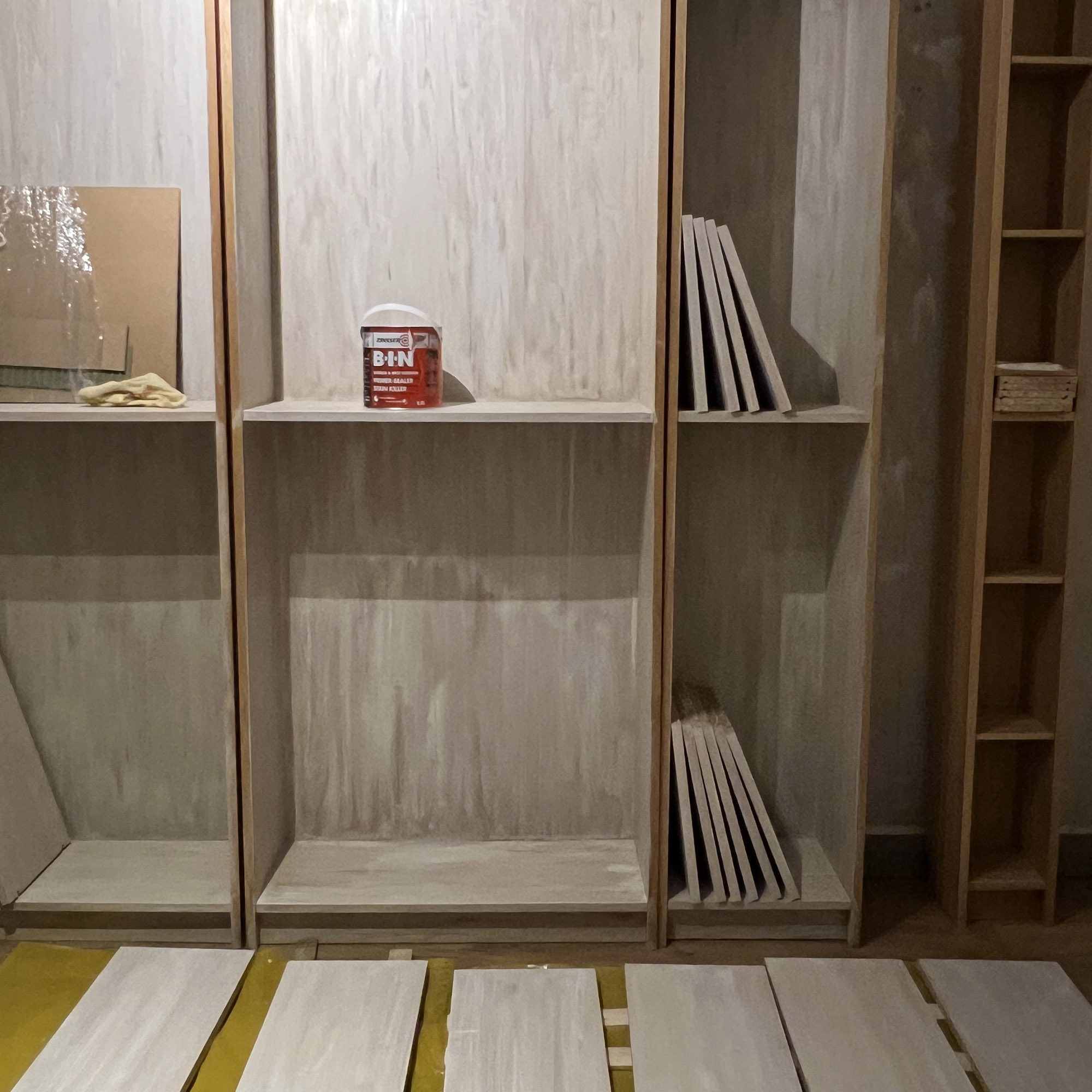 diy project halfway through of a bookcase being primed