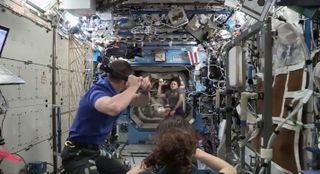 NASA astronauts Jessica Meir, Drew Morgan and Christina Koch play some baseball on the International Space Station in October 2019 to celebrate the World Series between the Washington Nationals and the Houston Astros.
