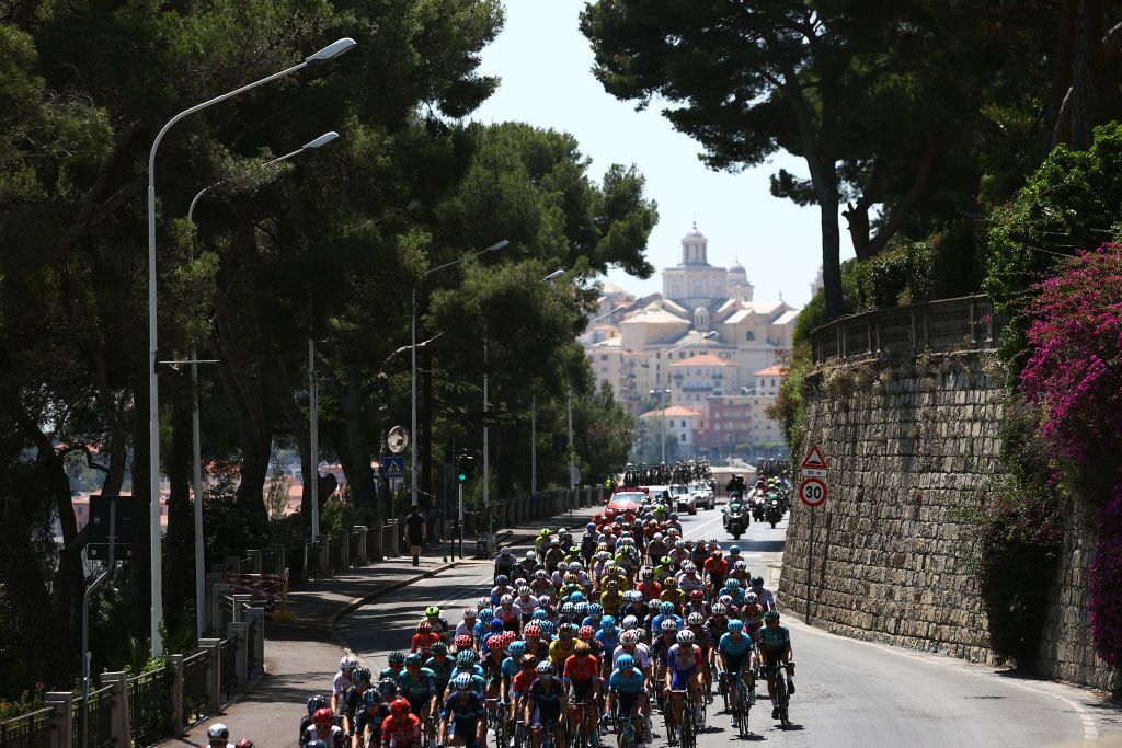 CUNEO ITALY MAY 20 A general view of the peloton passing through Imperia city landscape during the 105th Giro dItalia 2022 Stage 13 a 150km stage from Sanremo to Cuneo 547m Giro WorldTour on May 20 2022 in Cuneo Italy Photo by Michael SteeleGetty Images