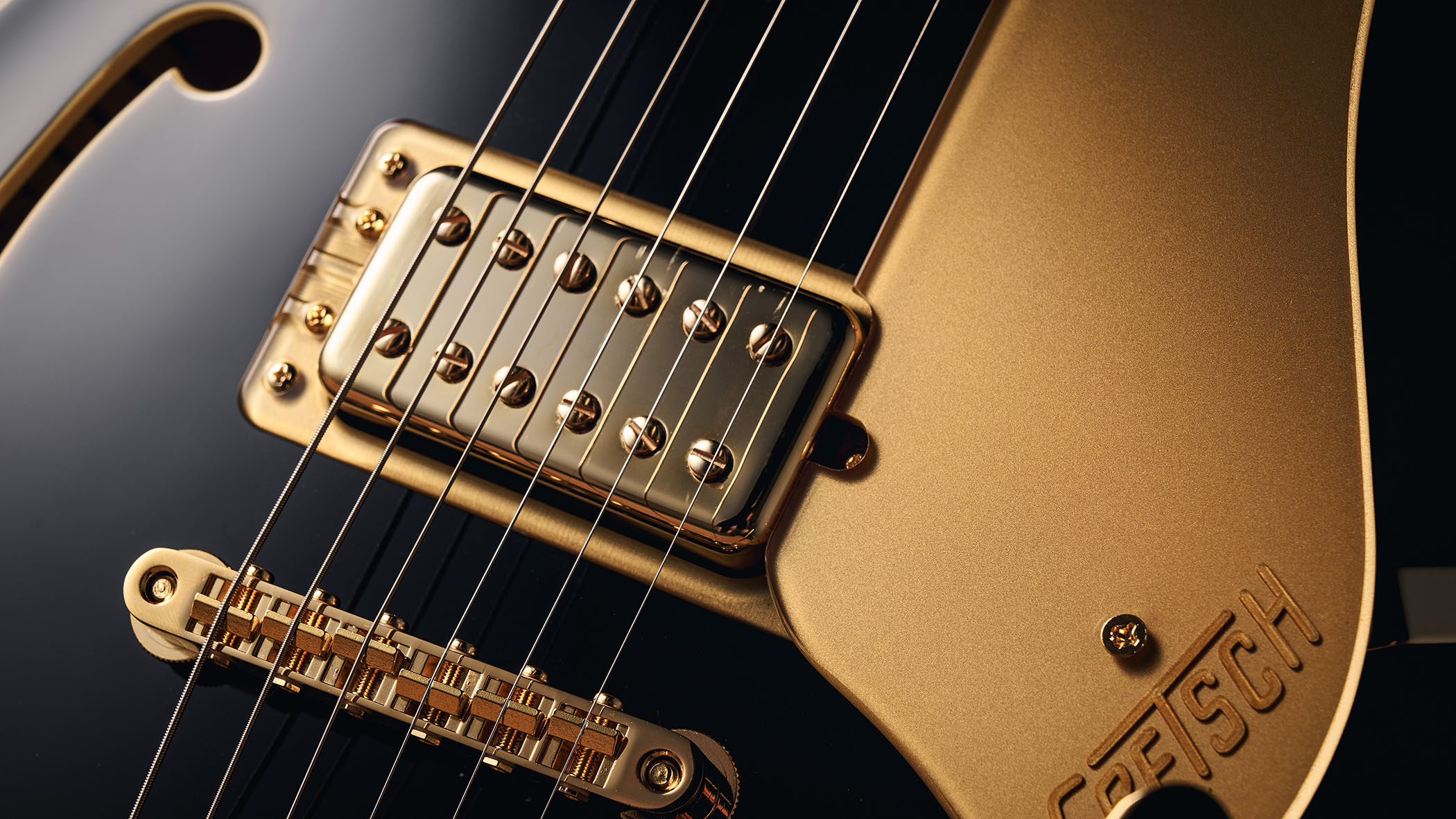 Gretsch Professional Collection Broadkaster LX Center Block: the handsome semi-hollow is finished in black with gold hardware and here is photographed in close-up.