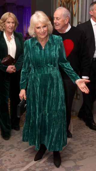 Queen Camilla in a green velvet dress.