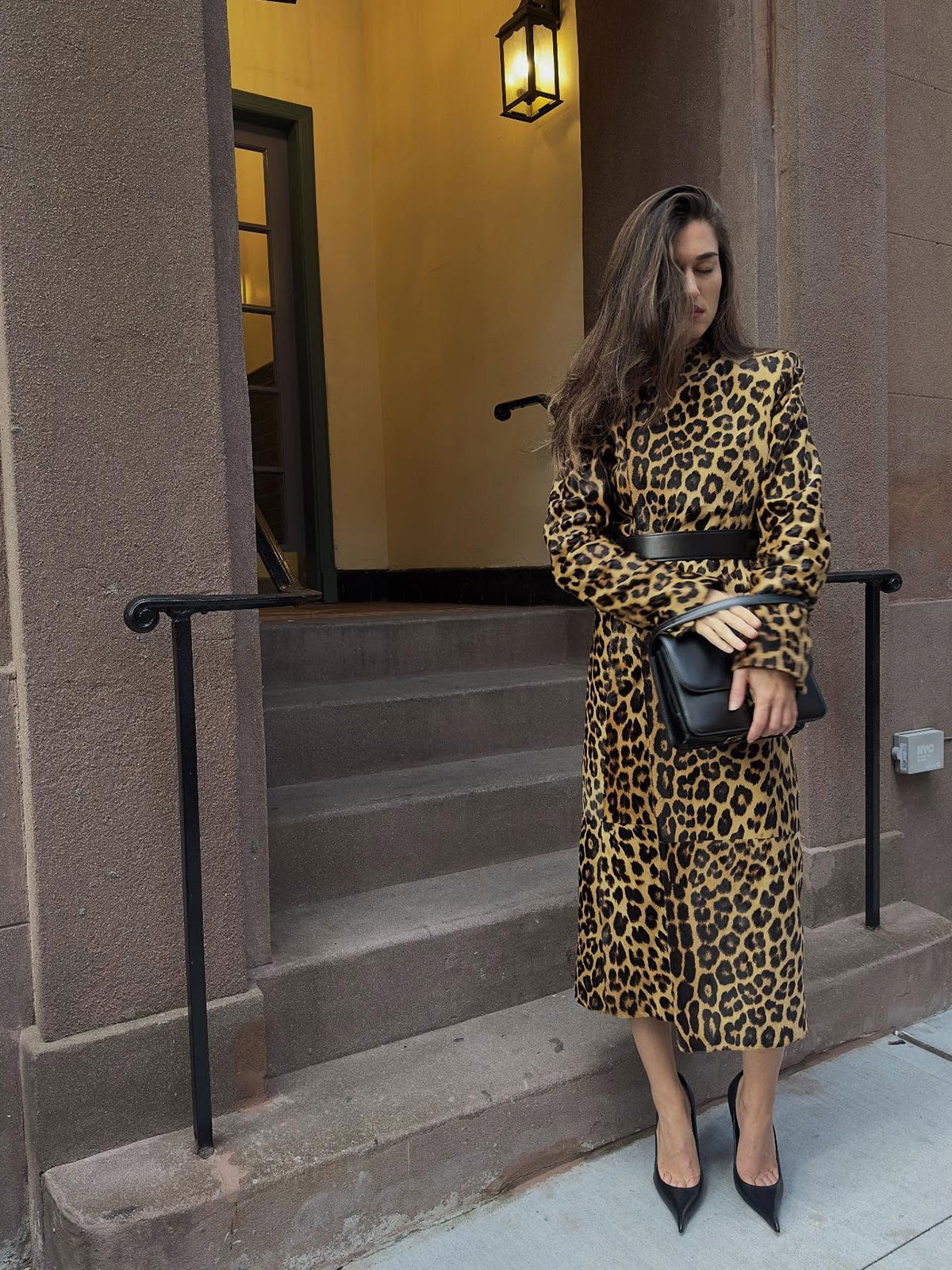 Woman wearing the animal-print coat trend of fall/winter 2025.