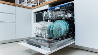 Open dishwasher showing a clean load