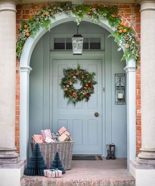 Wreath with fruit, wicker basket of presents