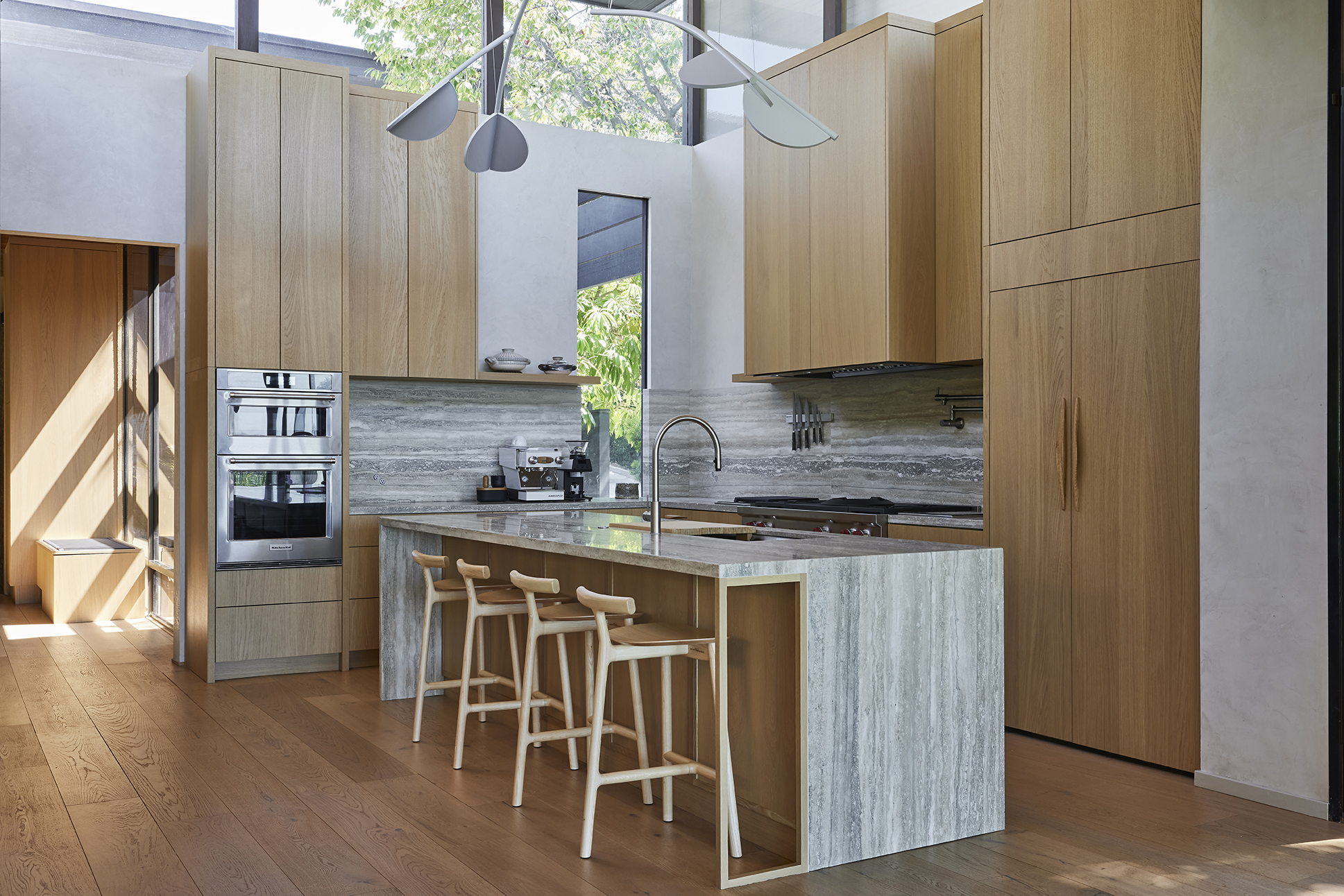 Bathed in natural light, the kitchen combines refined materiality and understated detailing, creating a space designed for gathering, ritual, and everyday living.