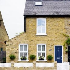 sloping roof house with exposed yellow brick walls