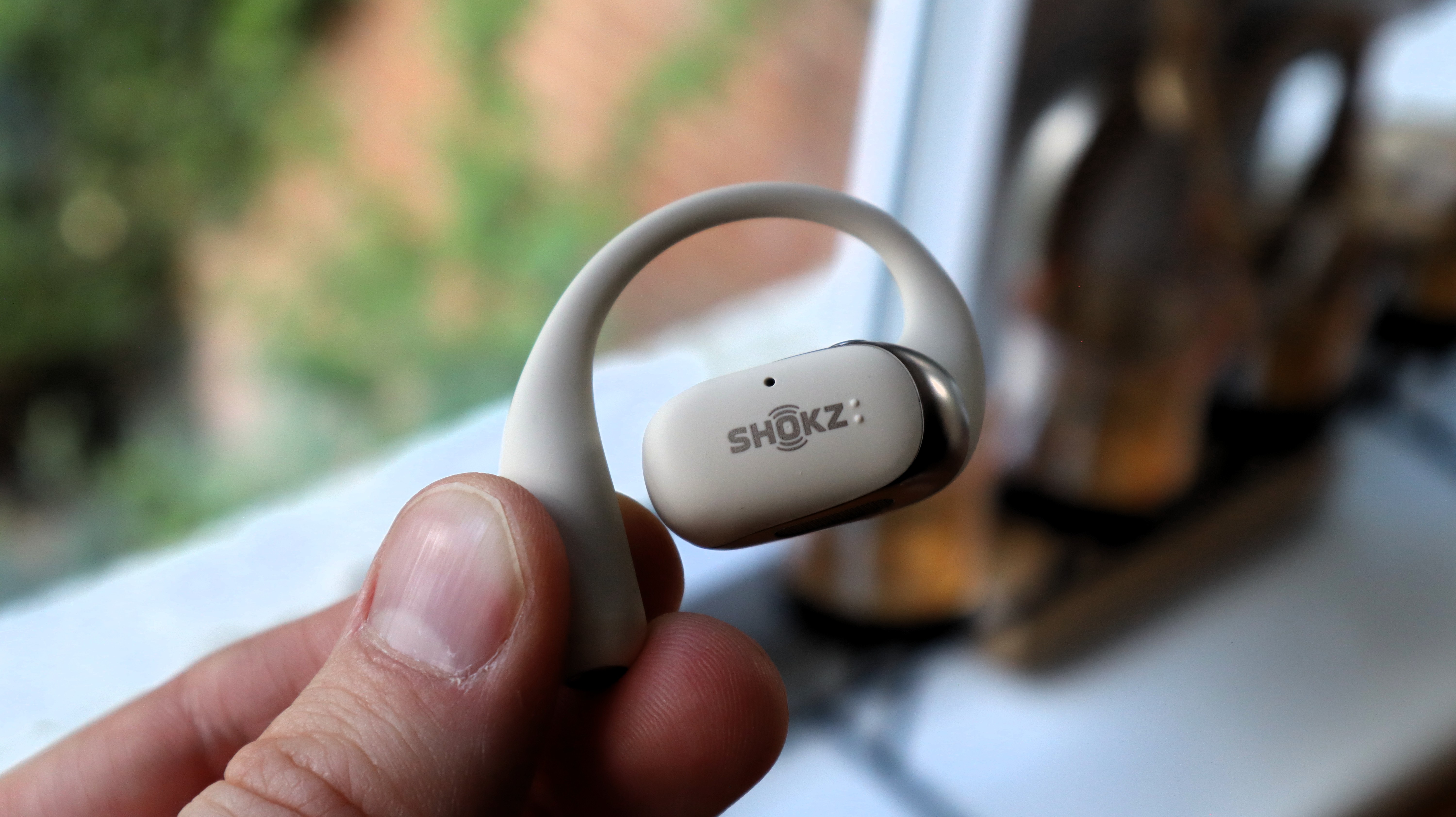 Shokz OpenFit 2 on a wooden table