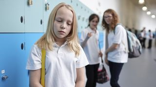 Girl being bullied by other girls in school