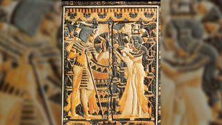 Tutankhamun receives flowers from Ankhesenamun. This image is on the lid of a box found in Tut's tomb.