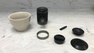Wacaco Picopresso parts on a marble countertop