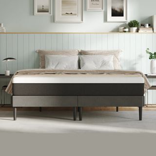 The Emma Original mattress on a bed in a bedroom with pale green walls