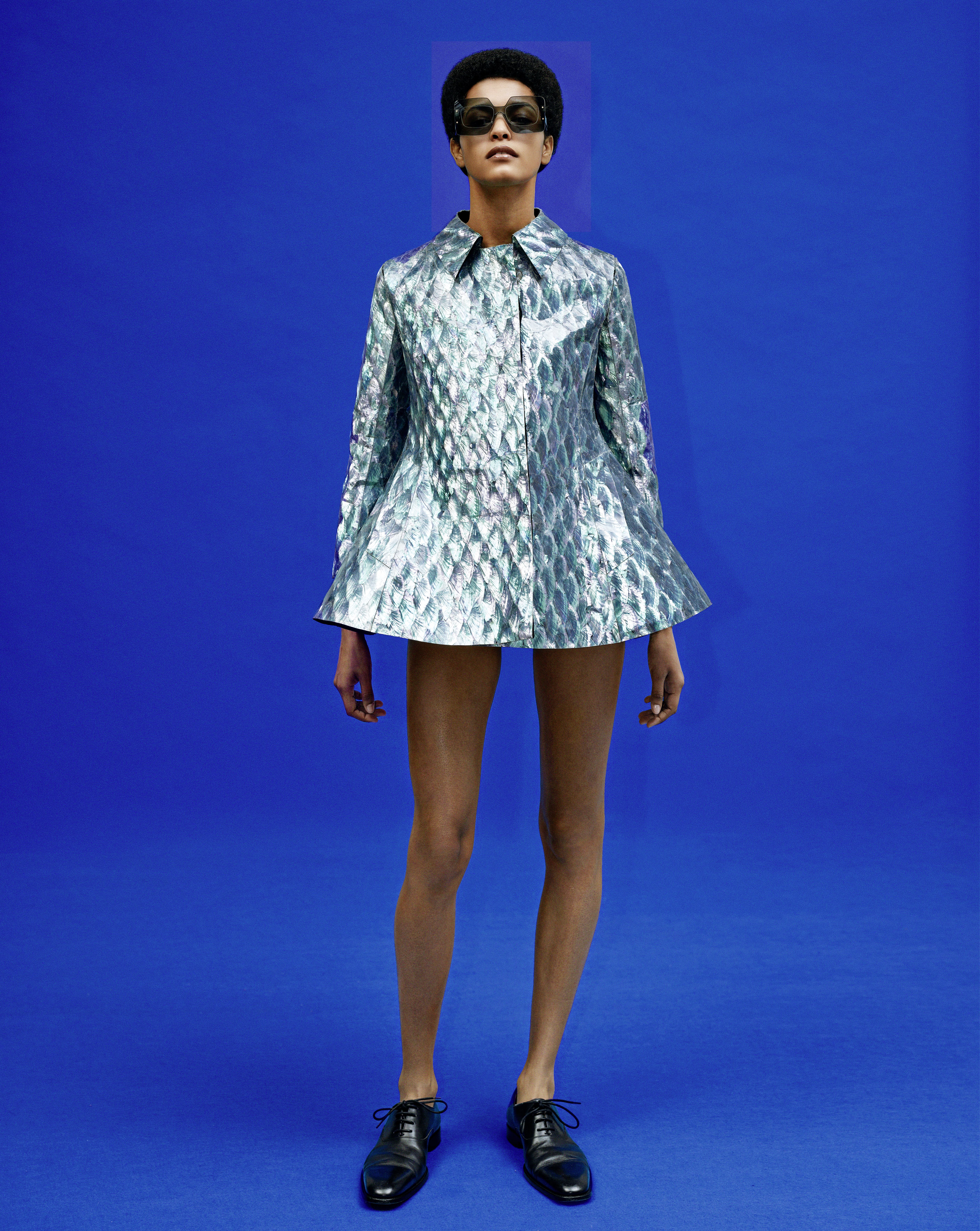 Model wearing a mini dress and oxford shoes