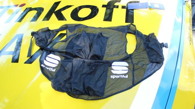 Tinkoff-Saxo Bank has a new vest for carrying seven water bottles. Instead of cramming the bottles inside a jersey, a rider just slides on this Sportful vest that a mechanic has loaded up inside the car