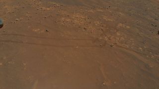NASA’s Ingenuity Mars Helicopter captured this image of tracks made by the Perseverance rover during its ninth flight, on July 5 2021.